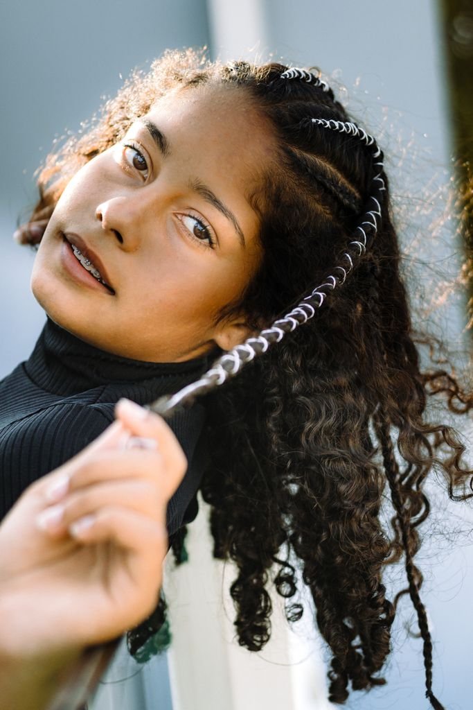Boho knotless braids with loose curly strands for a soft lived-in look