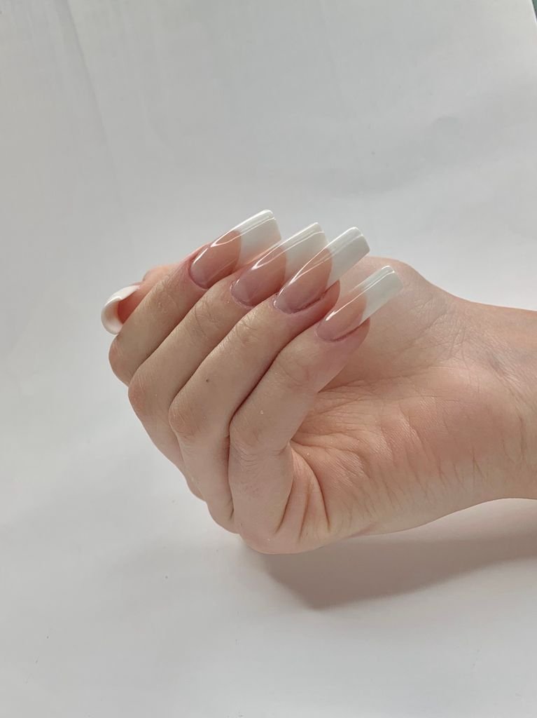 Classic French manicure with white tips on a nude base