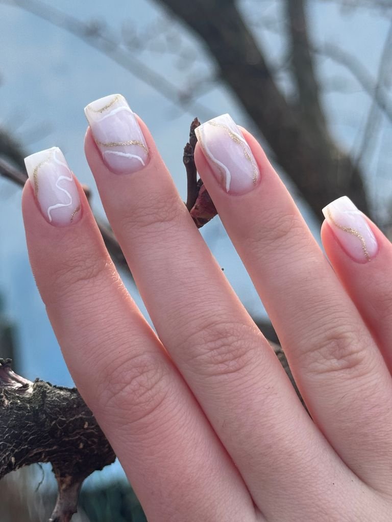 Double French manicure with two parallel tip lines in gold and white
