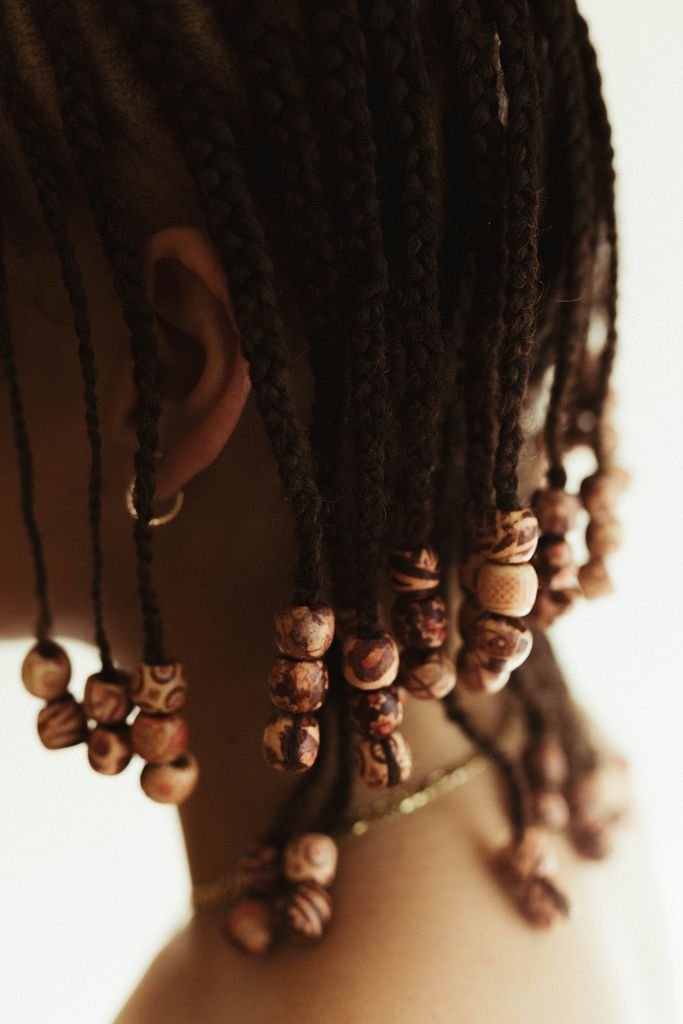 Fulani braids with wooden beads and cowrie shell accents