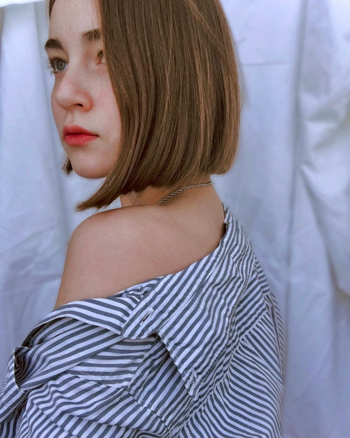 Precision one-length blunt bob haircut in a sleek chin-grazing silhouette