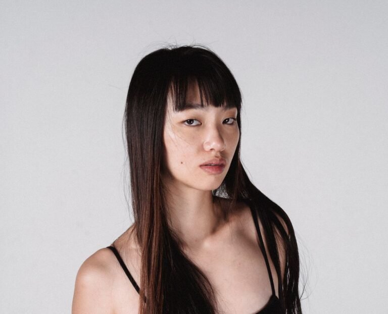 Young woman with long straight hair and Korean see-through wispy bangs — wispy bangs hairstyles