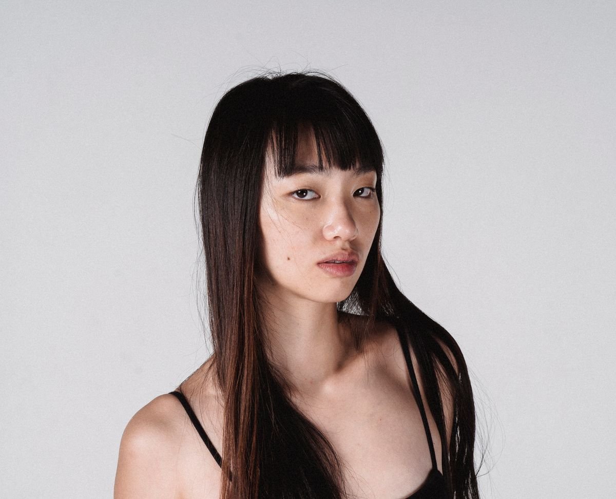 Young woman with long straight hair and Korean see-through wispy bangs — wispy bangs hairstyles