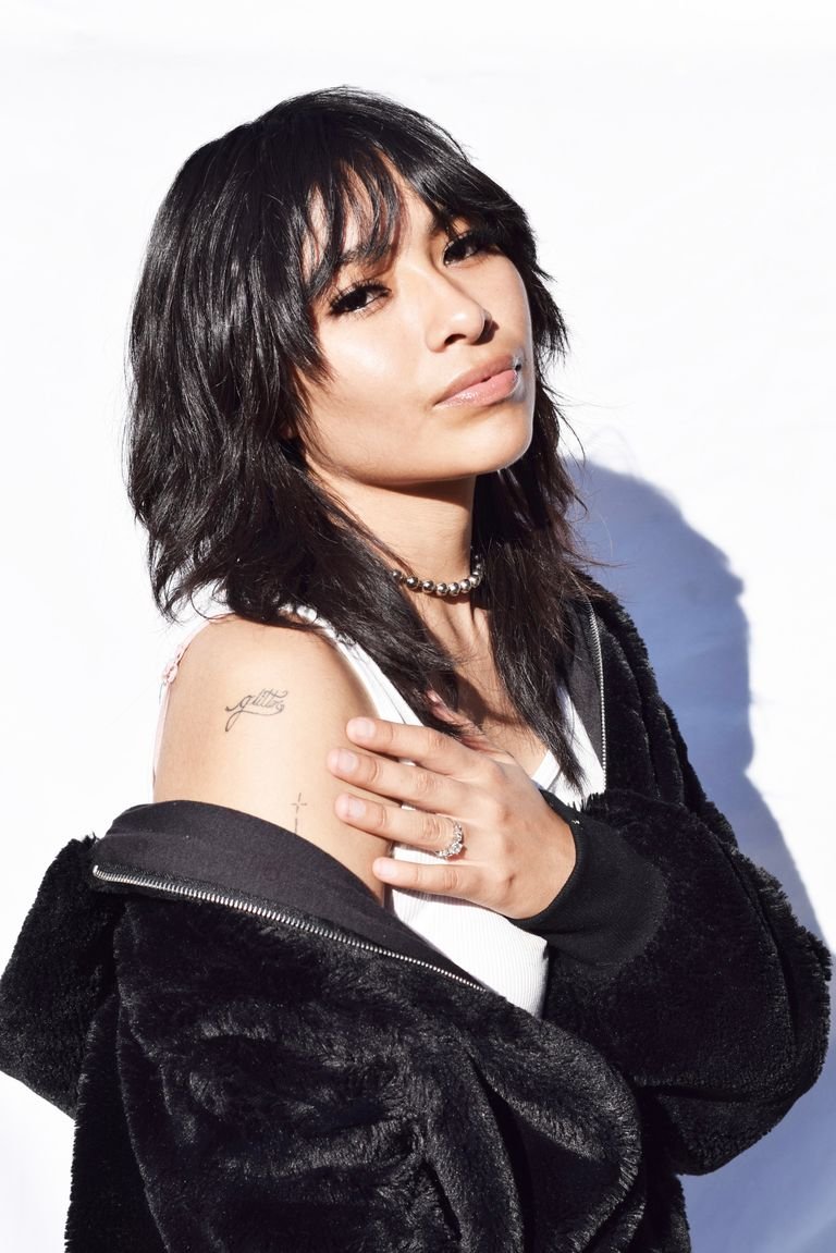 Young woman with textured Korean wolf cut layers and bangs — korean wolf cut hairstyle